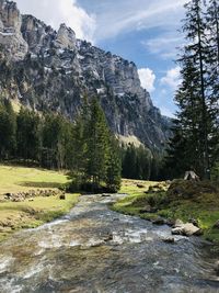 Scenic view of waterfall against sky