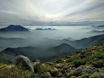 Scenic view of mountains against sky during foggy weather