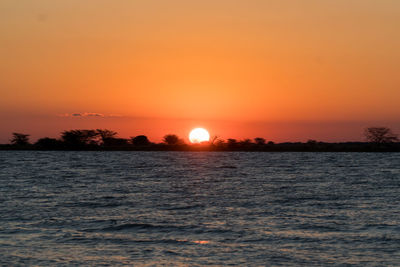 Scenic view of sea against romantic sky at sunset