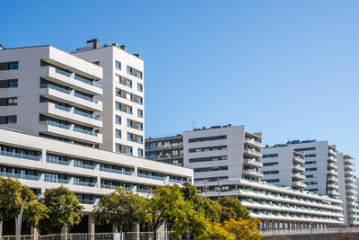 Low angle view of buildings against clear blue sky