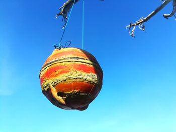 Low angle view of lighting equipment against clear blue sky