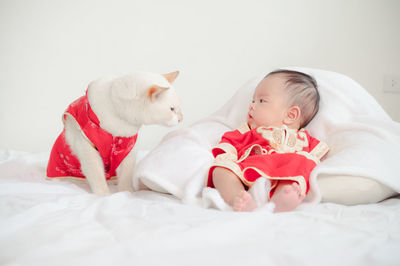 Cute baby girl lying on bed