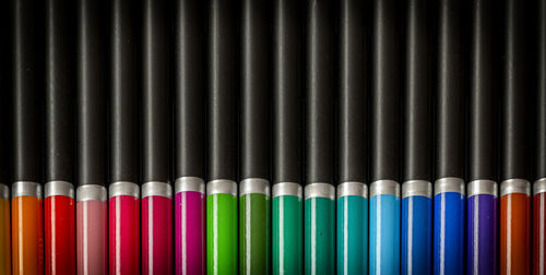 Close-up of multi colored pencils against black background