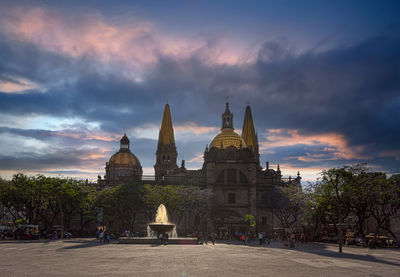 View of temple building against cloudy sky