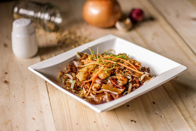 High angle view of food in plate on wooden table