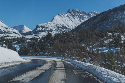 A picturesque landscape view of the road in the snowcapped french alps mountains