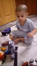 High angle view of boy playing with toy at home