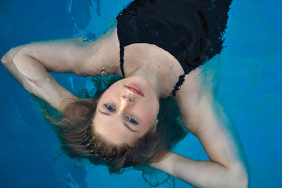 High angle portrait of woman swimming in pool