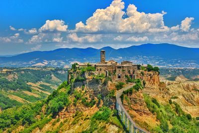 Old, deserted town in mountains against blue sky