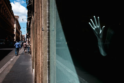 Mannequin hand in store seen through window