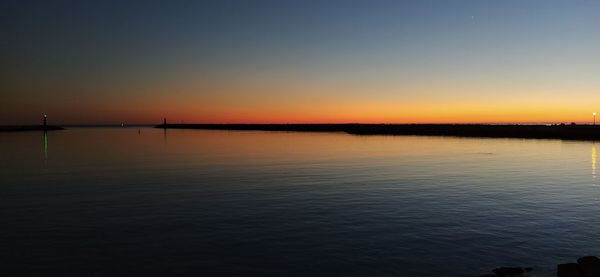 Scenic view of lake against orange sky