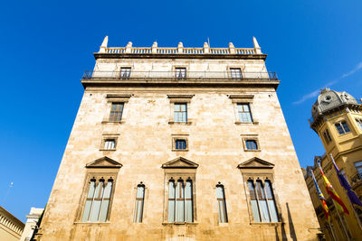 Low angle view of buildings against blue sky