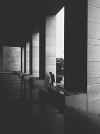 Silhouette man standing in corridor of building