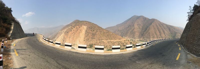 Panoramic view of road leading towards mountains