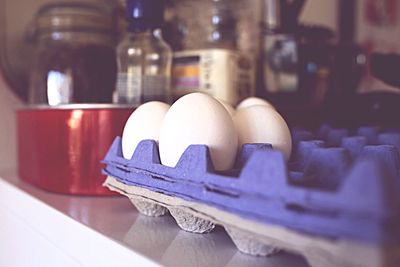 Close-up of eggs on crate in kitchen