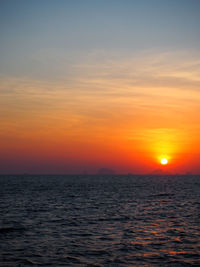 Scenic view of sea against romantic sky at sunset