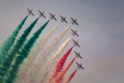 Low angle view of airplane flying against sky