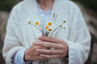 Close-up of woman holding flowers