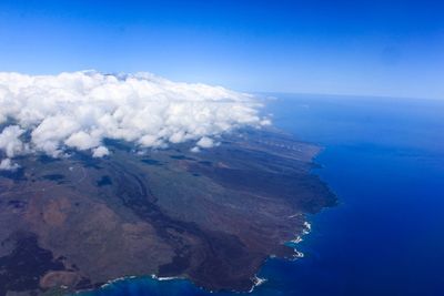 Aerial view of volcanic landscape against blue sky