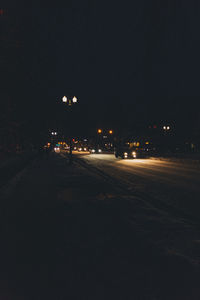 Illuminated city street at night