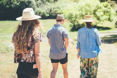 Rear view of people walking outdoors