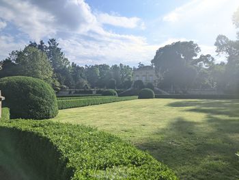 View of formal garden against sky