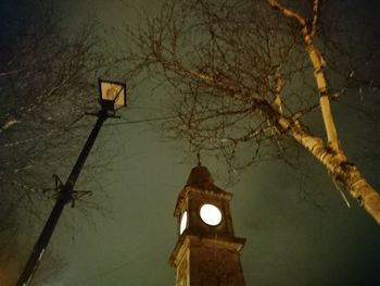 Low angle view of illuminated street light against building