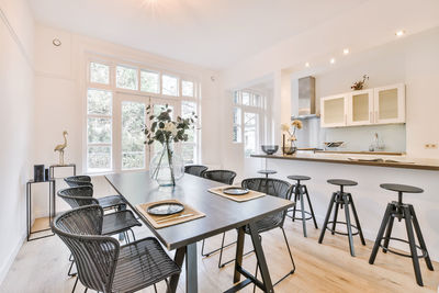 Empty chairs and table at kitchen