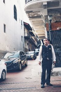 Full length of man standing in car