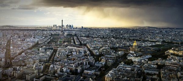 Cityscape against cloudy sky