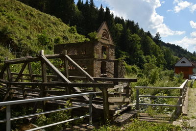 Built structure by trees against sky