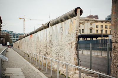 Berlin wall in city against clear sky