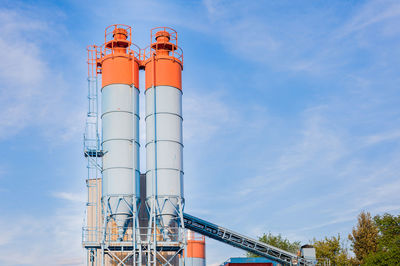 Low angle view of factory against blue sky