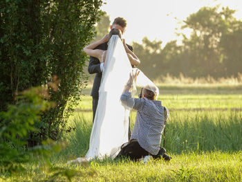 Rear view of couple on field