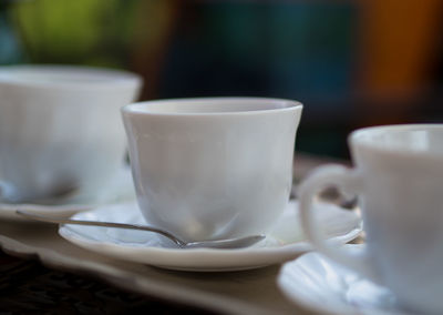 Close-up of coffee cups on table in cafe