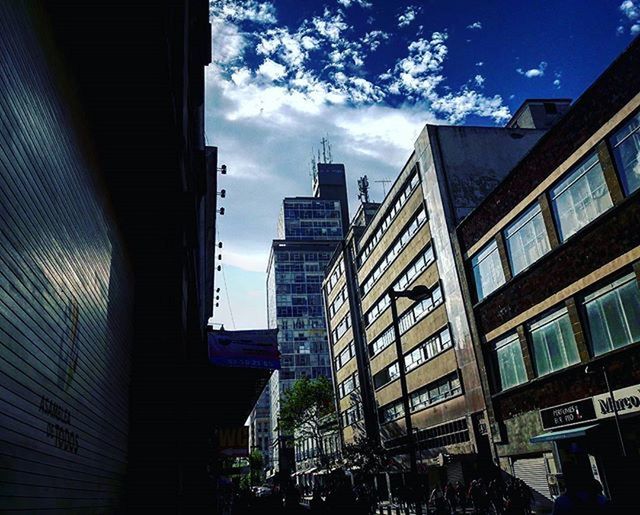 building exterior, architecture, built structure, sky, city, cloud - sky, cloud, building, residential building, residential structure, low angle view, window, city life, blue, sunlight, day, outdoors, residential district, cloudy