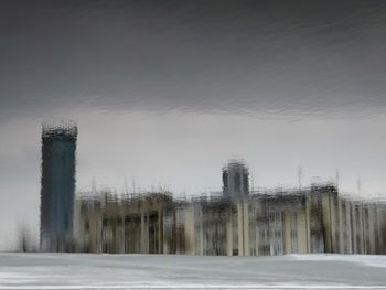 Snow covered built structure against sky