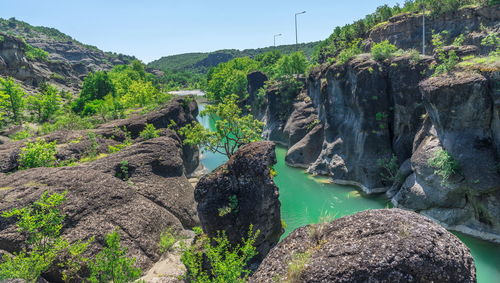 Scenic view of waterfall against sky