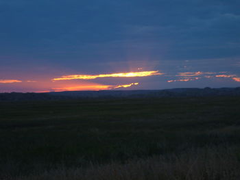 Scenic view of landscape against sky at sunset