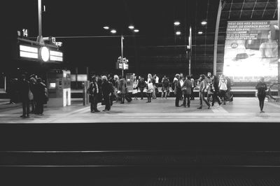 People walking on city street at night