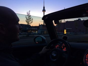 Cars on road at sunset