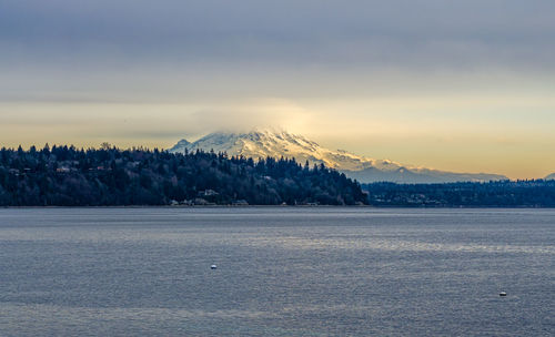 Clouds cover mount rainier across the puget sound in washington state.