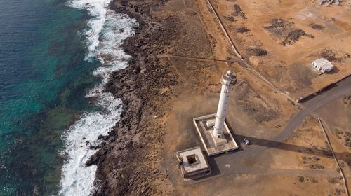 High angle view of lighthouse at beach