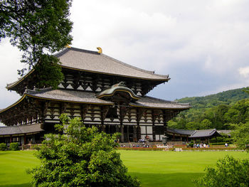 Todaiji temple by grassy field against sky