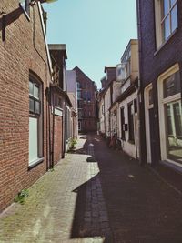 Empty alley amidst buildings in city