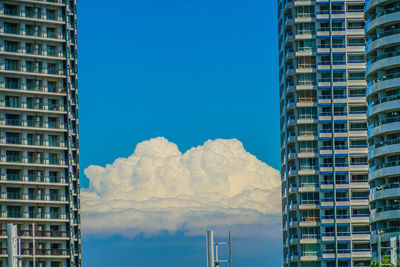 Low angle view of buildings against blue sky