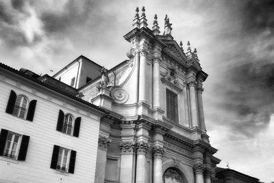 Low angle view of building against cloudy sky