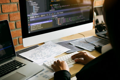 Midsection of woman using computer on table