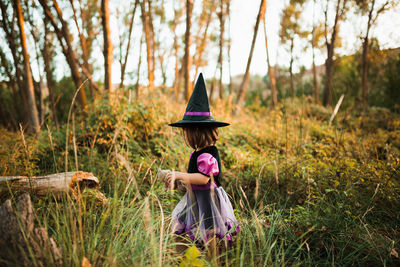 Girl wearing costume during halloween walking at forest