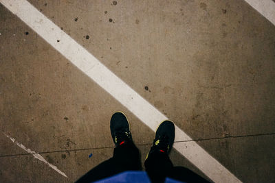 Low section of woman standing on tiled floor